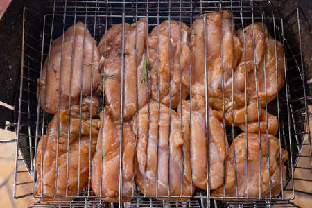 Marinated grilled chicken on the flaming grill.の写真素材