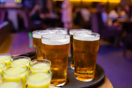 Bottle of vodka with shot glasses and slises of lemon. On dark stone background.の写真素材