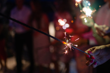 Picture showing group of friends having fun with sparklers.の写真素材