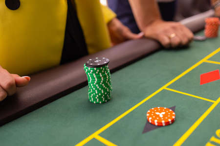 A close up of a blackjack dealers hands in a casino, very shallow depth of field.の写真素材