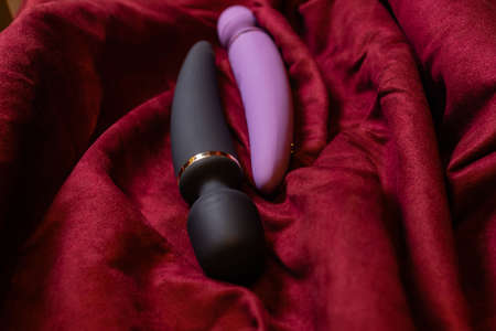 Woman in bedroom holding vibrator in handの写真素材
