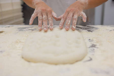 Close up of woman Kneading Pizza Dough.