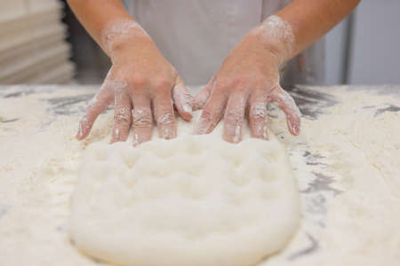 Close up of woman Kneading Pizza Dough.