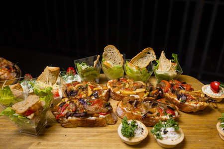Bruschetta with grilled bell pepper, zucchini, olives and mozzarella cheese. Vegetarian dish.の写真素材