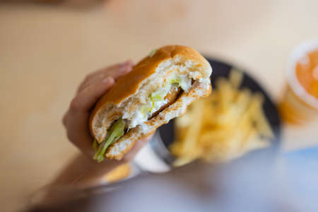 Close Up Of Female Hands Holding Delicious Bacon Burger.