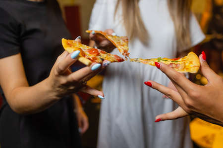 Group of people eating delicious pizza.の写真素材