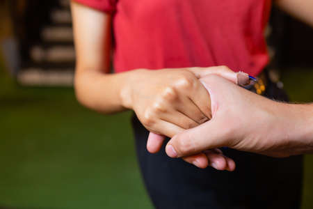 Couple hands closed together outdoors. Hand-in-hand. Couple love on background of nature.