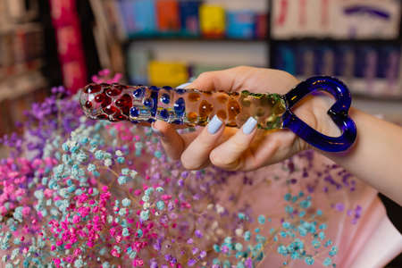 Anal glass butt plug with a fluffy tail with female hands. Toy for adult games.の写真素材