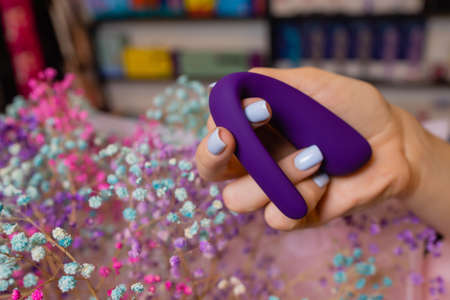 Girls hand holds a massager for sex. Vibrator for masturbation. Dildo for vaginal and clitoral...