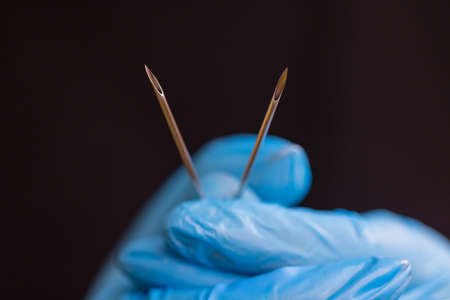 Professional holding the jewel of piercing just before screw the ball.の写真素材