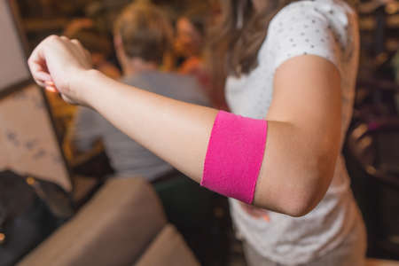 Kinesio tape on shoulder on beautiful girl. Alternative medicine rehab.の写真素材