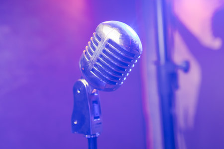 Retro microphone on stage in a pub or American Bar restaurant during a night show.の写真素材