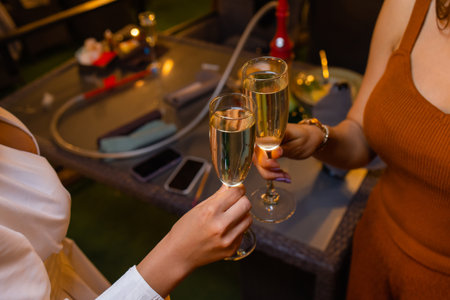 Celebration. People holding glasses of white wine making a toast.の写真素材