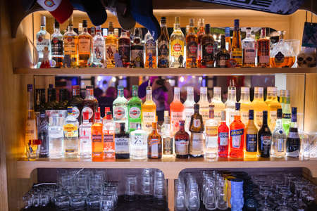 Ufa, Russia, 1 July, 2021: Several types of bottled alcohol are displayed on some shelves in a pub.のeditorial素材