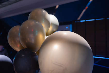 Silver star shaped helium balloons on blue.の写真素材