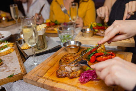 Grilled Steak Striploin and Pepper sauce on cutting board on dark wooden background.の写真素材