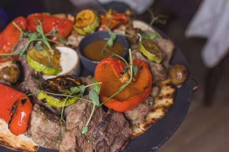 Grilled Steak Striploin and Pepper sauce on cutting board on dark wooden background.