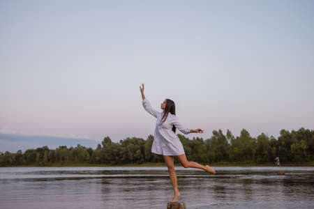 Outdoors fashion photo of beautiful bohemian lady at river.の写真素材