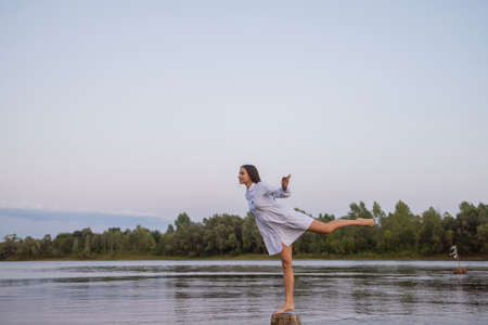 Outdoors fashion photo of beautiful bohemian lady at river.の写真素材