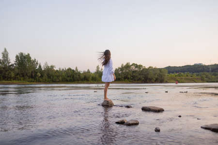 Outdoors fashion photo of beautiful bohemian lady at river.の写真素材