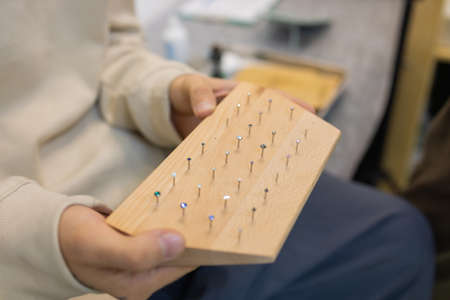 ear jewelry, piercing in hand with a disposable glove.