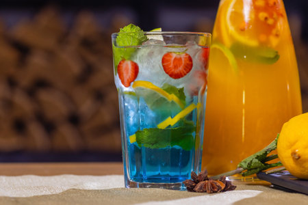 fruit and berry lemonades on the wooden tray with spruce.