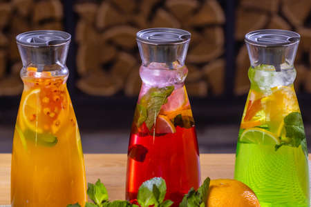 fruit and berry lemonades on the wooden tray with spruce.の写真素材