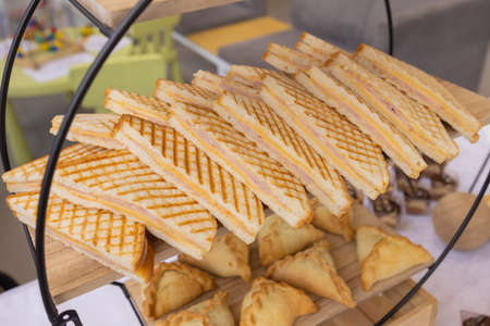 Different types of canapes on buffet table.