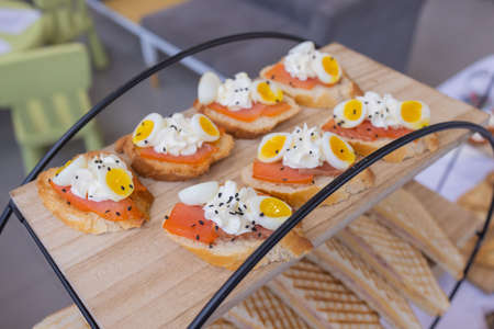 Different types of canapes on buffet table.
