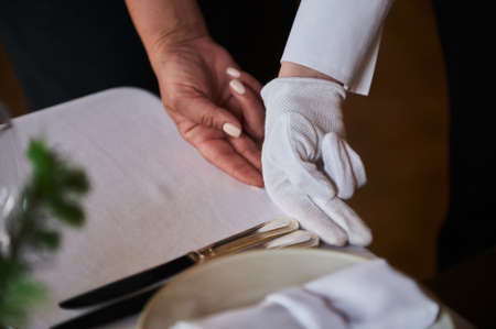 Restaurant personnel preparing the fine dining table.の写真素材