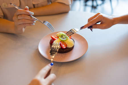 Chocolate muffins with strawberries and white cream on wooden table.の写真素材