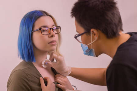 Operation to install microdermal piercing. Professional placingの写真素材