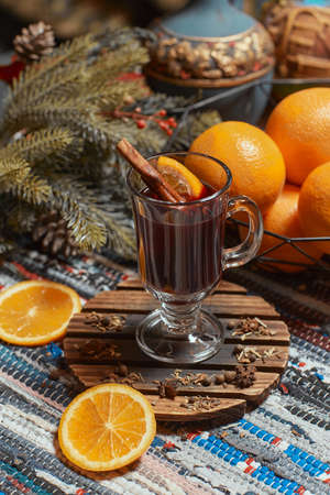 Mulled wine with cinnamon sticks and orange.
