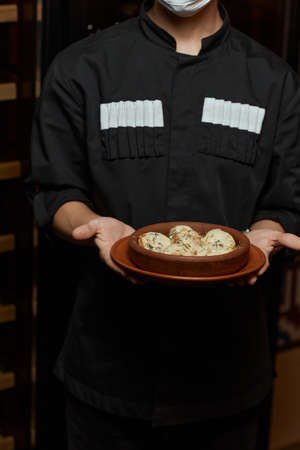 Georgian cuisine. Baked mushrooms champignons with meat, cheese, parsley and pomegranate. Serving in a restaurant in an iron pan. background image, copy space.の写真素材