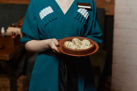 Georgian cuisine. Baked mushrooms champignons with meat, cheese, parsley and pomegranate. Serving in a restaurant in an iron pan. background image, copy space.の写真素材