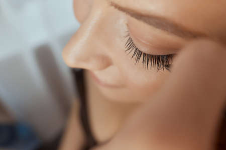 Eyelash Extension Procedure. Woman Eye with Long Eyelashes. Lashes. Close up, selected focus.の写真素材