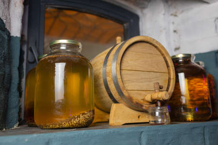 Beer barrel with beer glasses on a wooden table. The dark brown background.