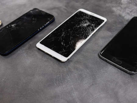 Broken mobile phone screen, black, white, clipping path. Smartphone monitor damage mock up. Cellphone crash and scratch. Telephone display glass hit. Device destroy problem. Smash gadget, need repair.の写真素材
