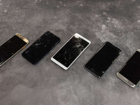 Broken mobile phone screen, black, white, clipping path. Smartphone monitor damage mock up. Cellphone crash and scratch. Telephone display glass hit. Device destroy problem. Smash gadget, need repair.の写真素材