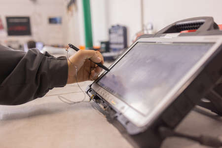 Professional car mechanic working in auto repair service.の写真素材