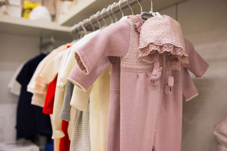 closeup of baby clothes on rack in a flea market.の写真素材