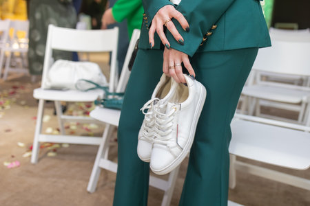 Business woman took off her black high-heeled shoes and massages her feet. Ankle pain from uncomfortable shoes.の写真素材