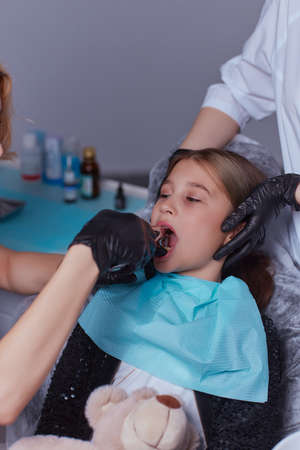 Dentist use anesthetic injection for tooth extraction in child.の写真素材