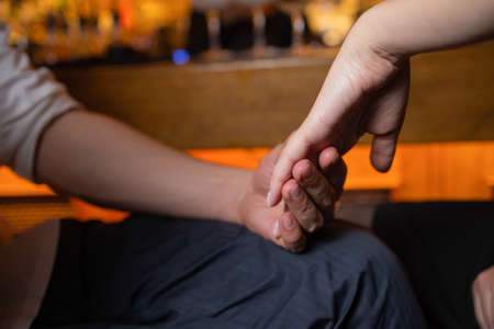 harassment in workplace. Unhappy female employee hand of boss touch feeling disgusted.の写真素材