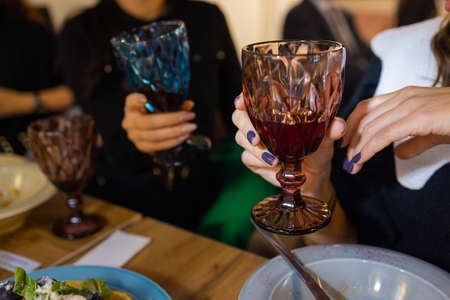 Celebration. People holding glasses of white wine making a toast.の写真素材