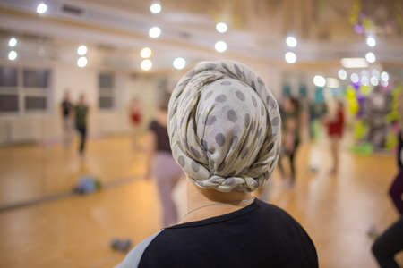 back shoot hijab woman stretching her arms. Female doing warmup stretching.の写真素材