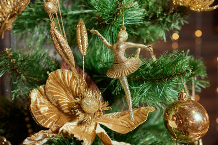 Fir branch with balls and festive lights on the Christmas background.