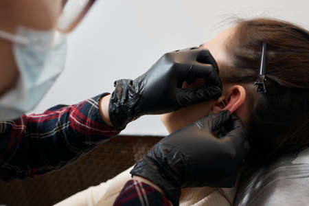 piercings on an ear. Conch and helix piercings close up.の写真素材