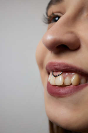 smile or frenulum piercing under the upper lip.の写真素材