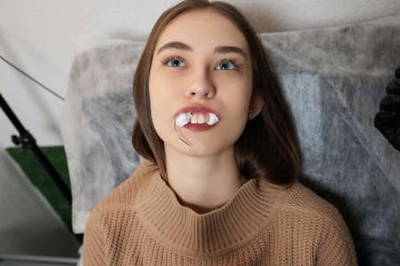 smile or frenulum piercing under the upper lip.